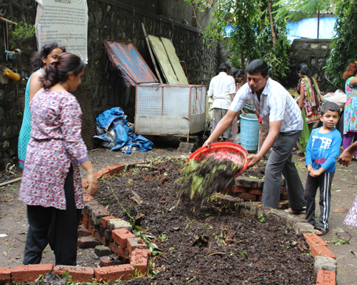 Then, the residents put a layer of compost over the organic waste matter