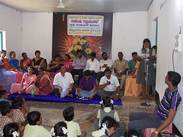 A girl reads out a list of the issues concerning the children in her panchayat.